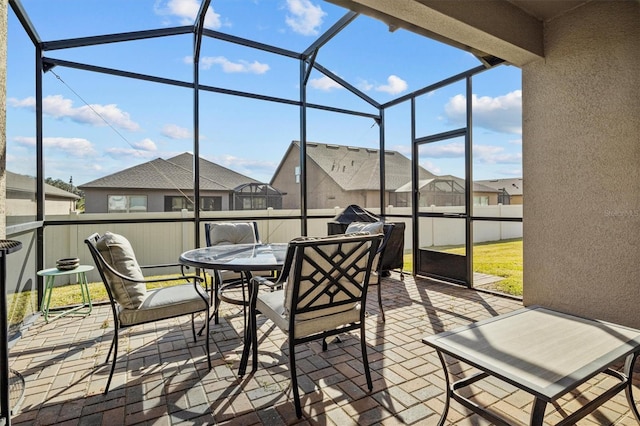 sunroom / solarium featuring a wealth of natural light and a residential view