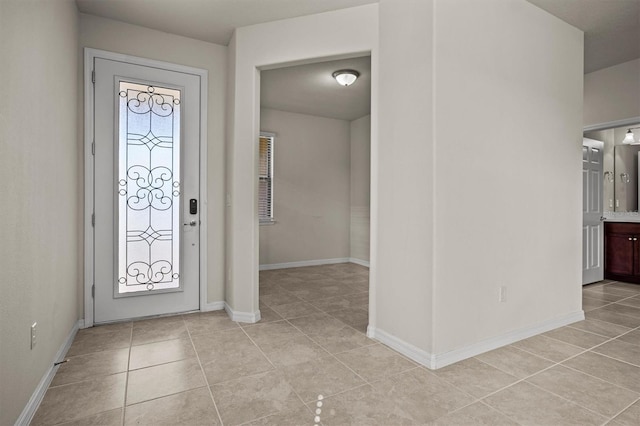 entryway featuring light tile patterned floors and baseboards