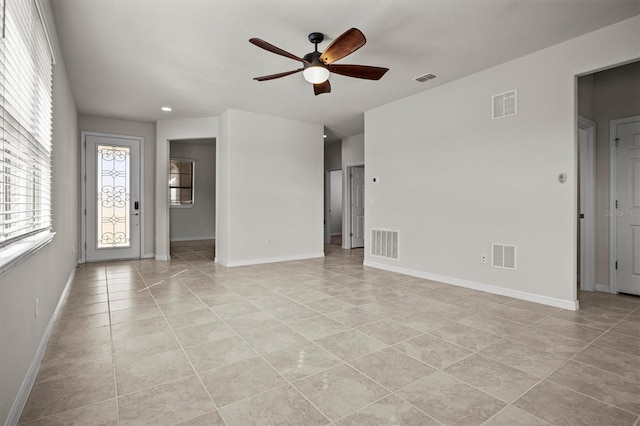 spare room with a ceiling fan and visible vents