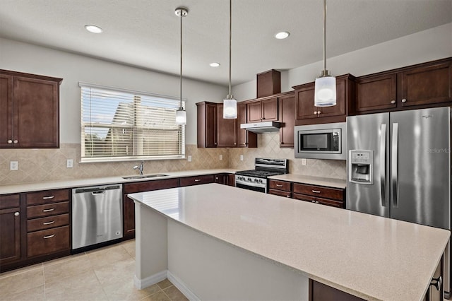 kitchen with a sink, dark brown cabinetry, appliances with stainless steel finishes, and light countertops