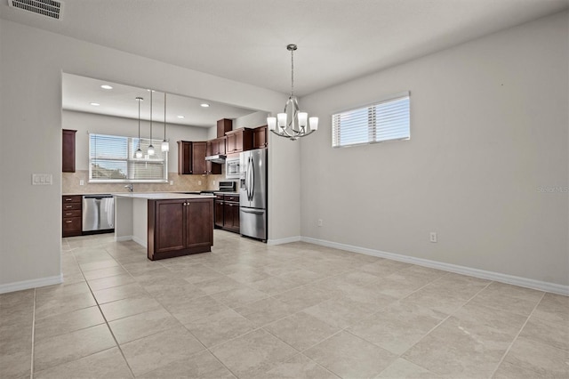 kitchen with visible vents, a chandelier, light countertops, decorative backsplash, and stainless steel appliances