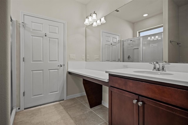 bathroom with tile patterned floors, a stall shower, vanity, and baseboards