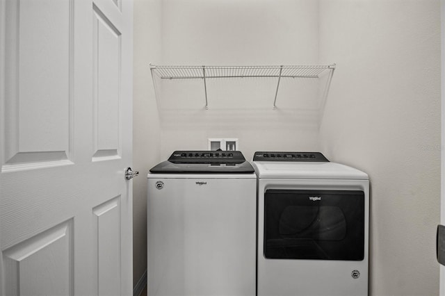 clothes washing area featuring laundry area and separate washer and dryer