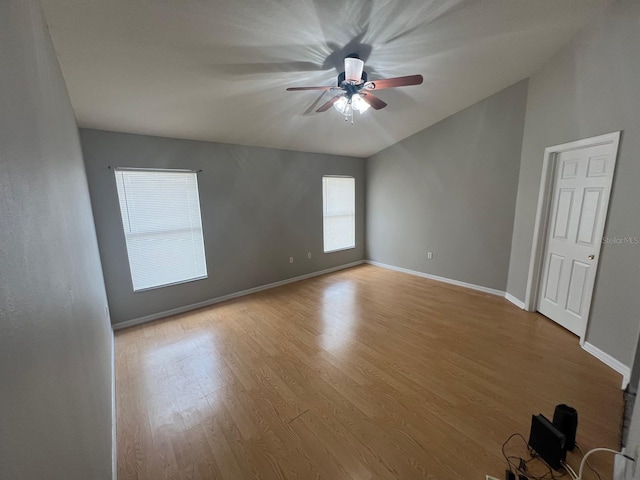 spare room with ceiling fan, wood finished floors, and baseboards