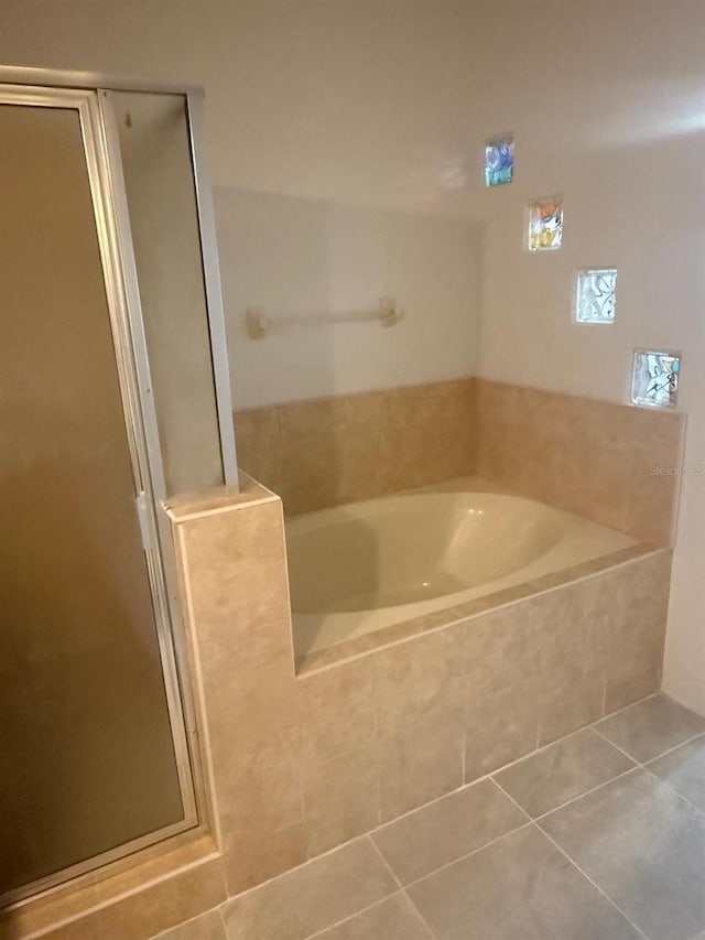 228 Remington Pl, Haines City, FL 33844 - full bathroom with tile patterned floors, a garden tub, and a shower stall