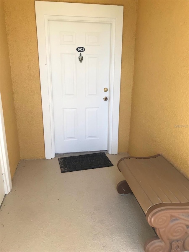 property entrance featuring stucco siding