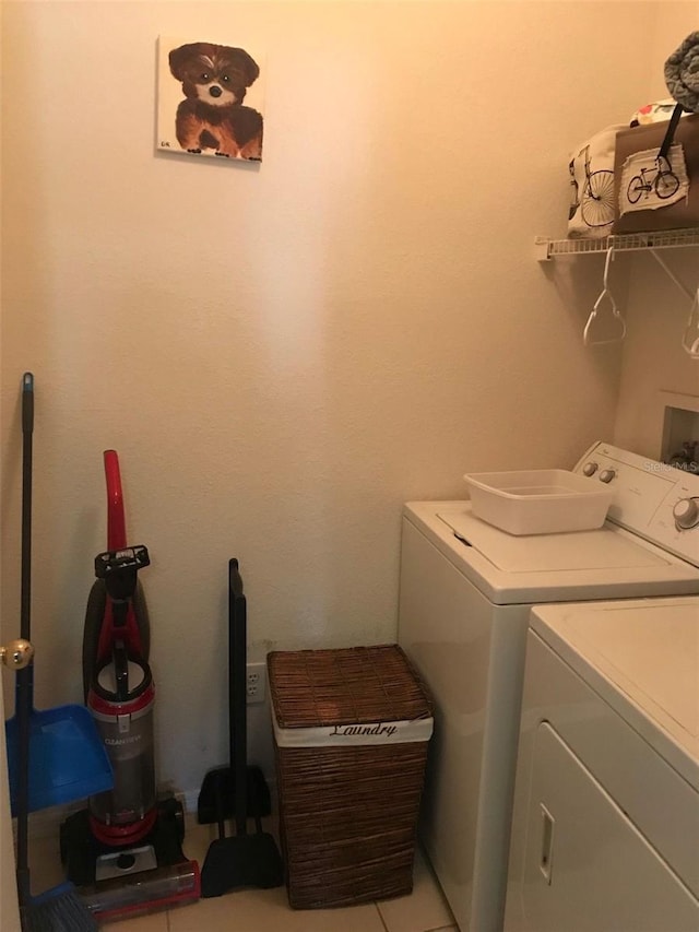 laundry area featuring separate washer and dryer and light tile patterned floors