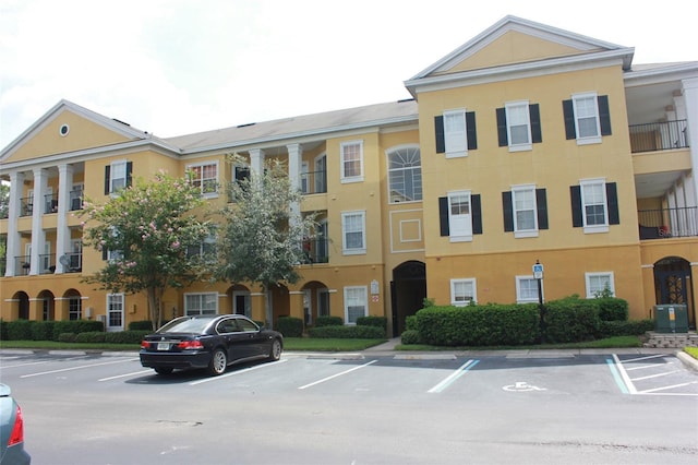 view of building exterior featuring uncovered parking