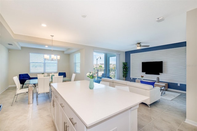 kitchen featuring pendant lighting, white cabinetry, a wealth of natural light, and a kitchen island