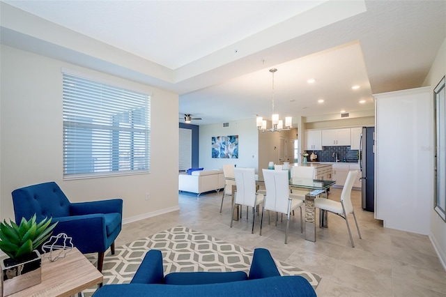 dining space featuring light tile patterned floors and a notable chandelier