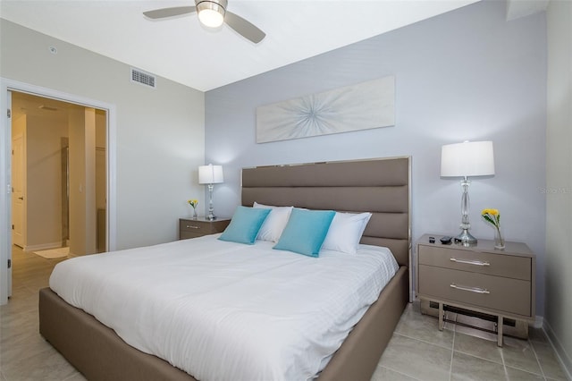 tiled bedroom with ensuite bathroom and ceiling fan