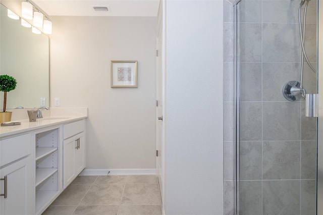 bathroom with vanity, an enclosed shower, and tile patterned flooring