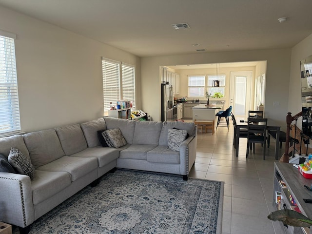 tiled living room featuring a wealth of natural light