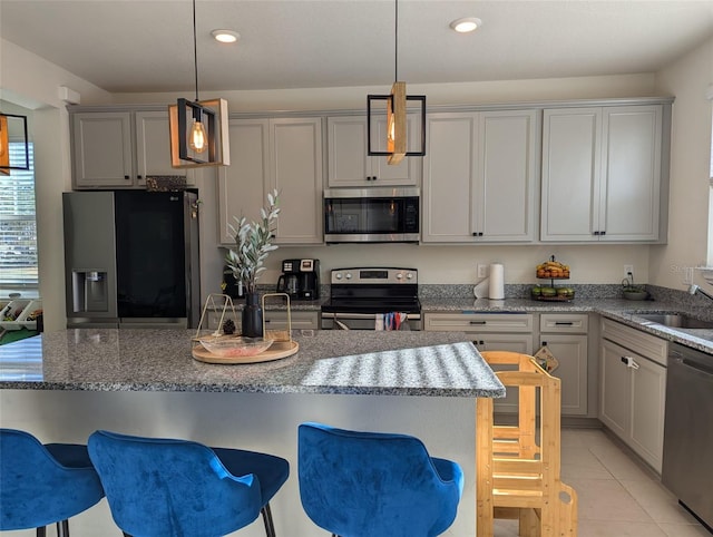 kitchen with pendant lighting, stainless steel appliances, and a center island