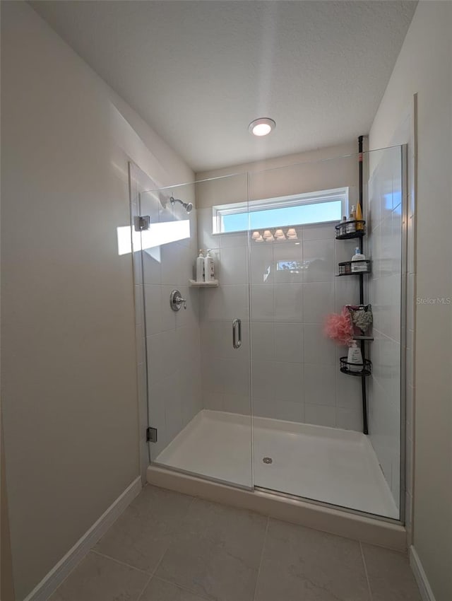 bathroom featuring tile patterned floors and an enclosed shower