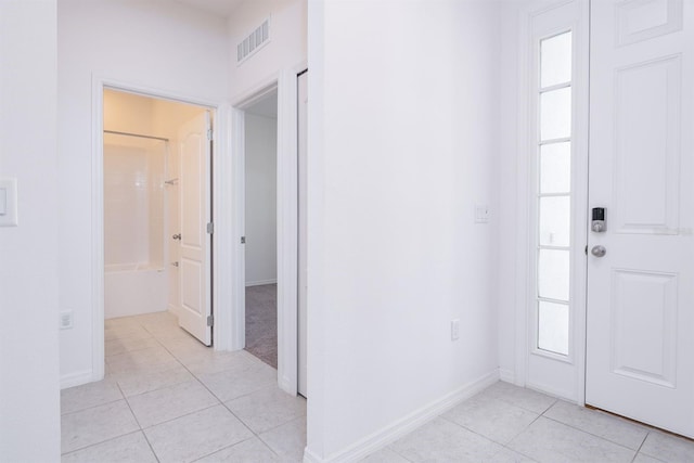 entryway with light tile patterned floors