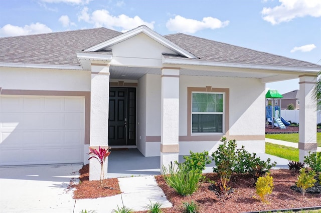 doorway to property with a garage