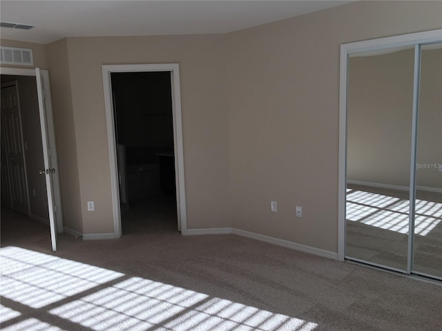 unfurnished bedroom featuring carpet and a closet