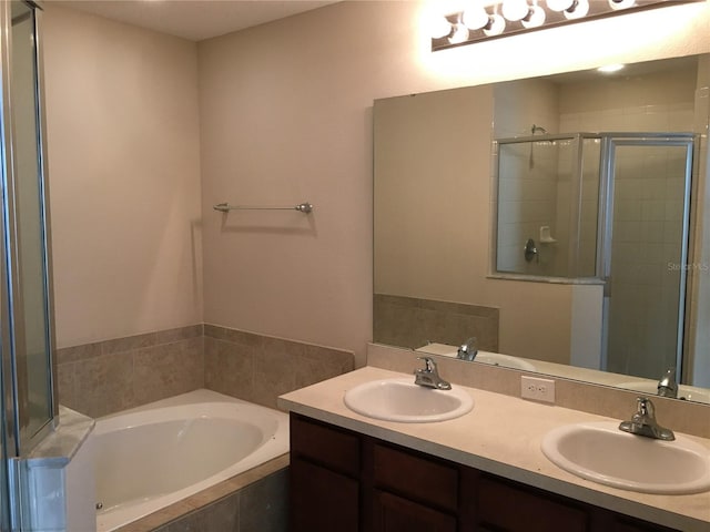 bathroom with vanity and independent shower and bath