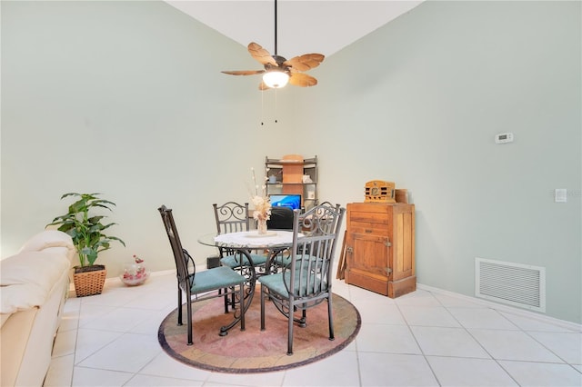 tiled dining area featuring high vaulted ceiling and ceiling fan