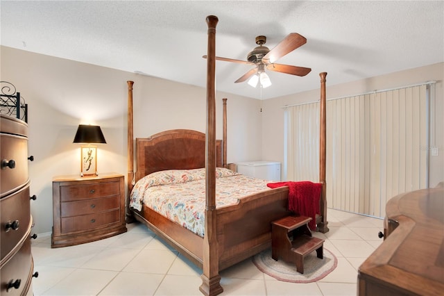 tiled bedroom featuring a textured ceiling and ceiling fan