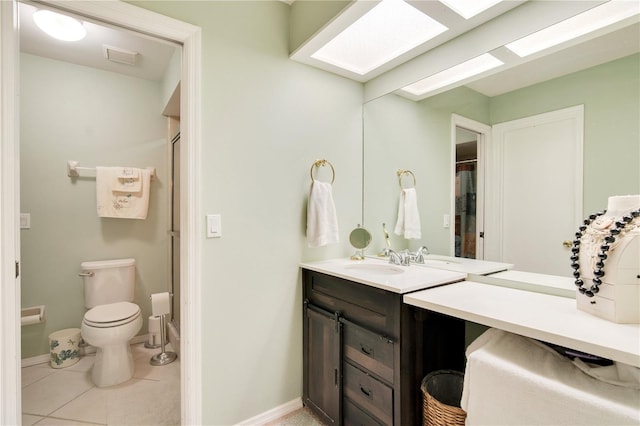 bathroom featuring a skylight, vanity, curtained shower, tile patterned floors, and toilet