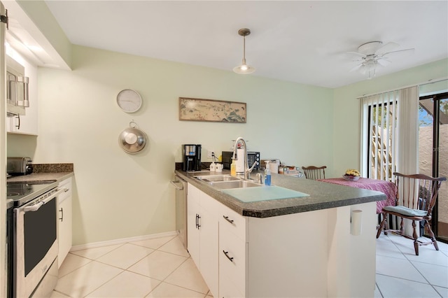 kitchen with light tile patterned floors, appliances with stainless steel finishes, white cabinetry, hanging light fixtures, and kitchen peninsula