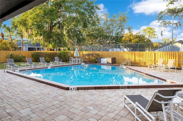 view of swimming pool with a patio