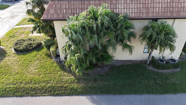 view of property exterior featuring a lawn