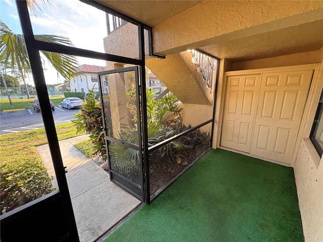 entryway featuring dark carpet