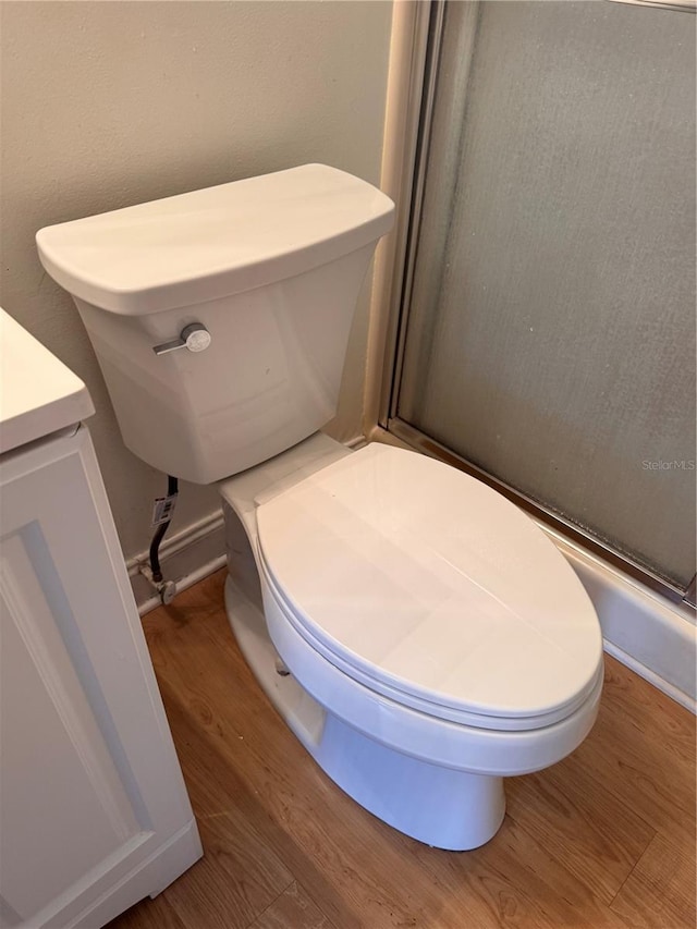 bathroom featuring hardwood / wood-style flooring, vanity, and toilet