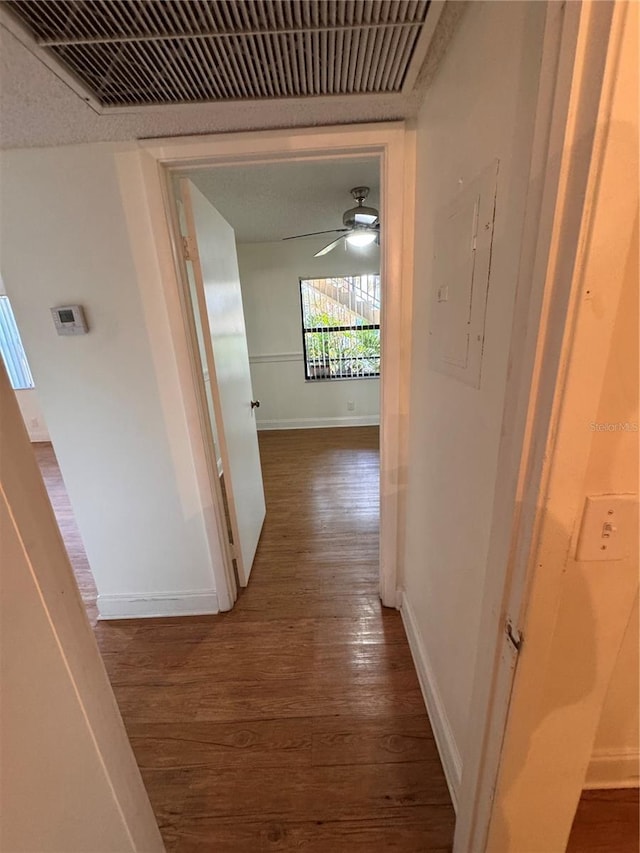 hall featuring dark wood-type flooring and electric panel