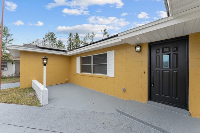 entrance to property featuring a patio