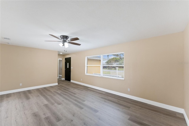 unfurnished room featuring ceiling fan and light wood-type flooring