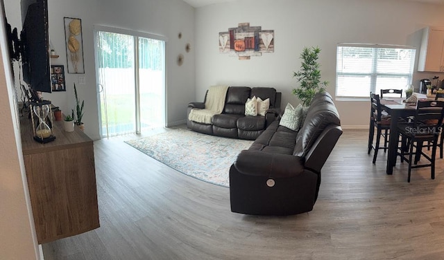 living area with wood finished floors and baseboards