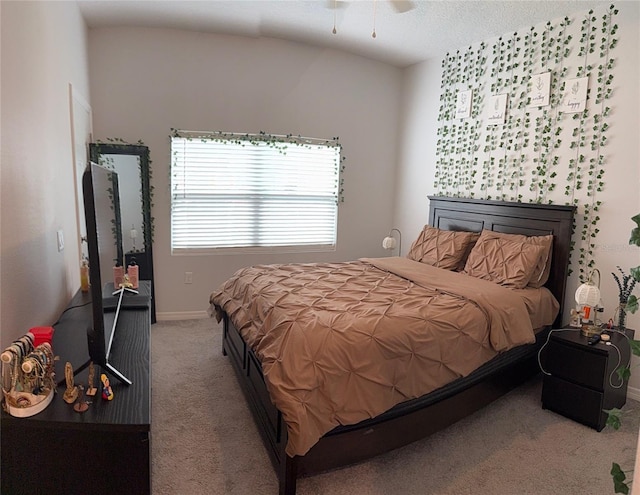 carpeted bedroom featuring baseboards and vaulted ceiling