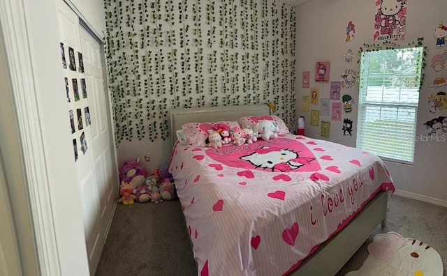 carpeted bedroom featuring a closet and baseboards