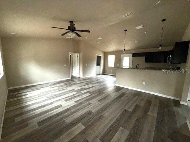 unfurnished living room featuring ceiling fan, dark hardwood / wood-style floors, and high vaulted ceiling