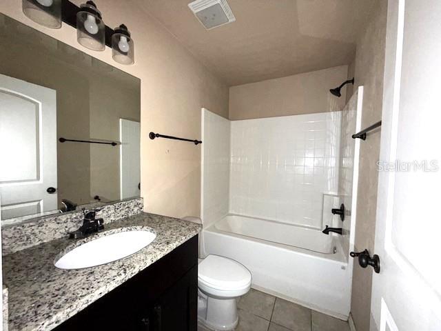 full bathroom with vanity,  shower combination, tile patterned floors, and toilet