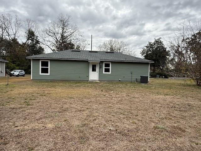 rear view of house featuring a lawn