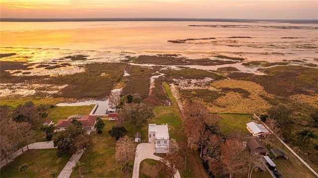 aerial view at dusk with a water view