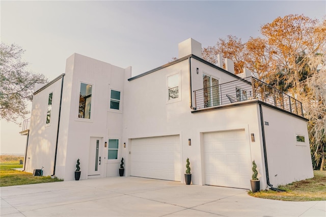 exterior space featuring a garage and a balcony