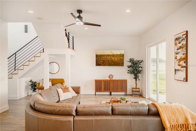 living room featuring hardwood / wood-style floors and ceiling fan