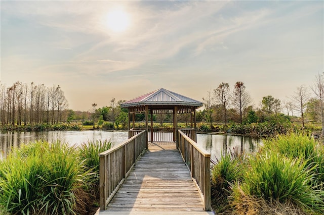 view of dock featuring a gazebo and a water view