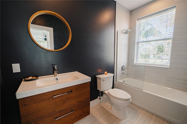 full bathroom with tiled shower / bath combo, vanity, tile patterned floors, and toilet