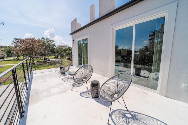 view of patio featuring a balcony