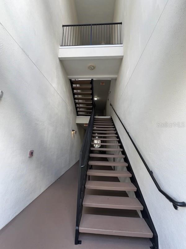 staircase featuring a high ceiling