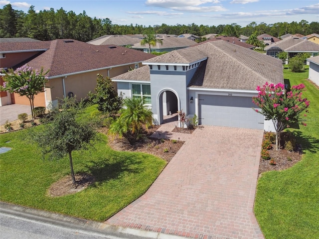 view of front of property with a garage and a front yard