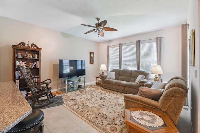 living room featuring light tile patterned flooring and ceiling fan