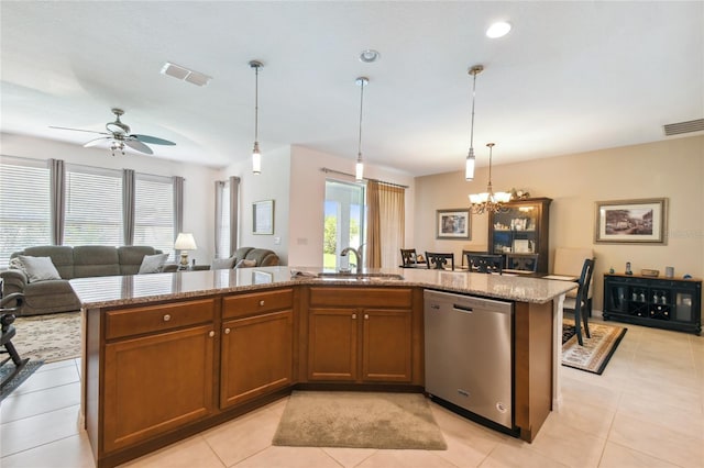 kitchen with sink, a wealth of natural light, stainless steel dishwasher, and a center island with sink